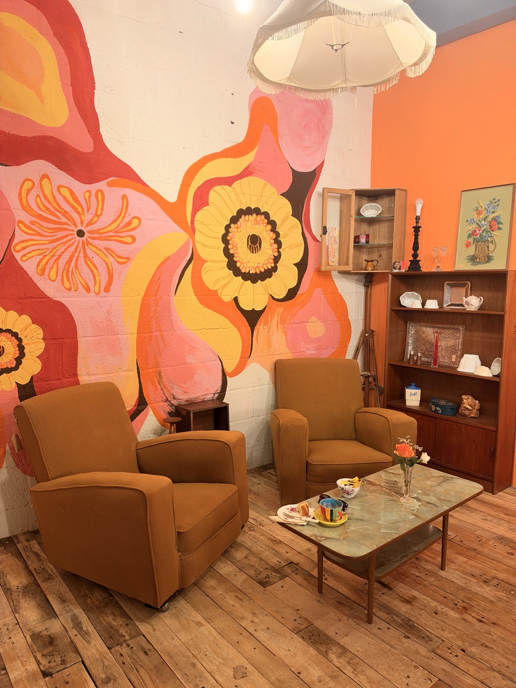 The painted mural and two armchairs inside Pia’s Place